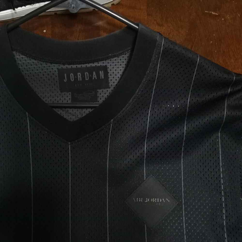 Men's all black pin stripe jersey size medium.